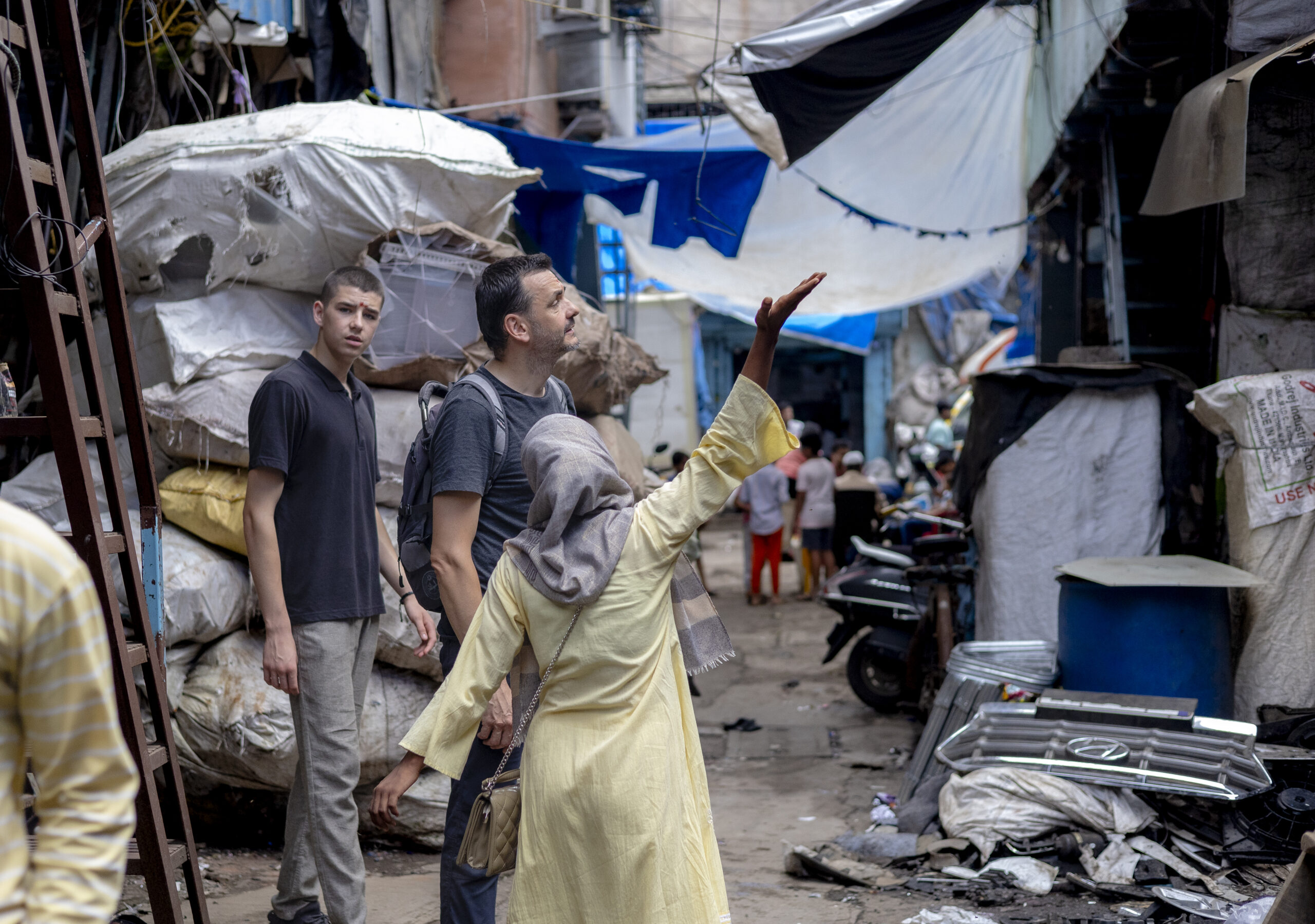 our guide walking client through dharavi slum tour