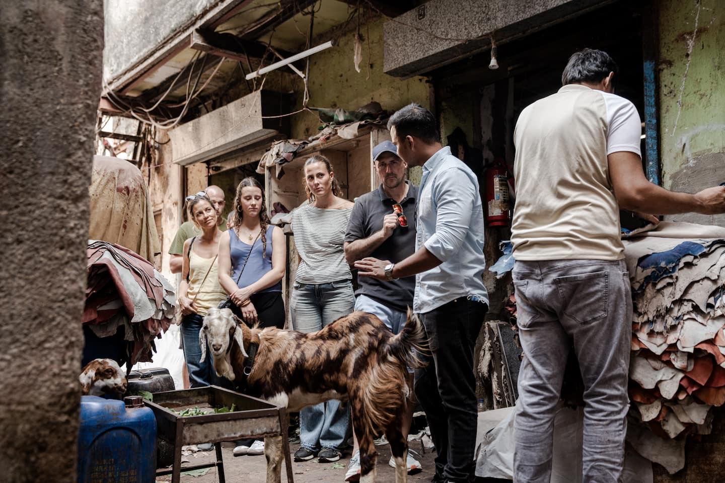 A local guide walks tourists through Dharavi Mumbai's famous leather industry - one of the most unique experiences on the tour.