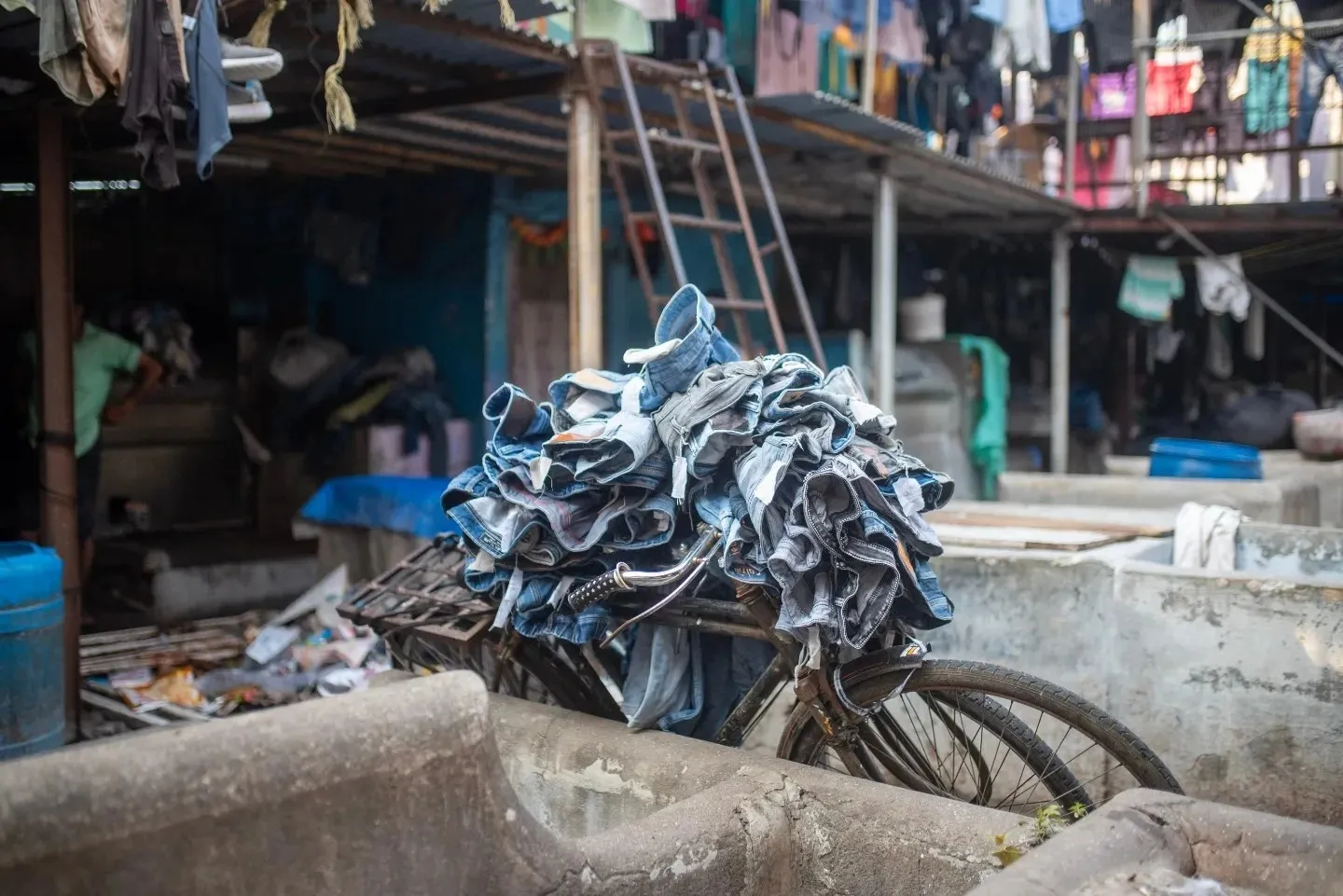 Every day at Dhobi Ghat, hundreds of garments travel by bicycle from the wash pens to the drying lines — a system that has worked the same way for over a century.