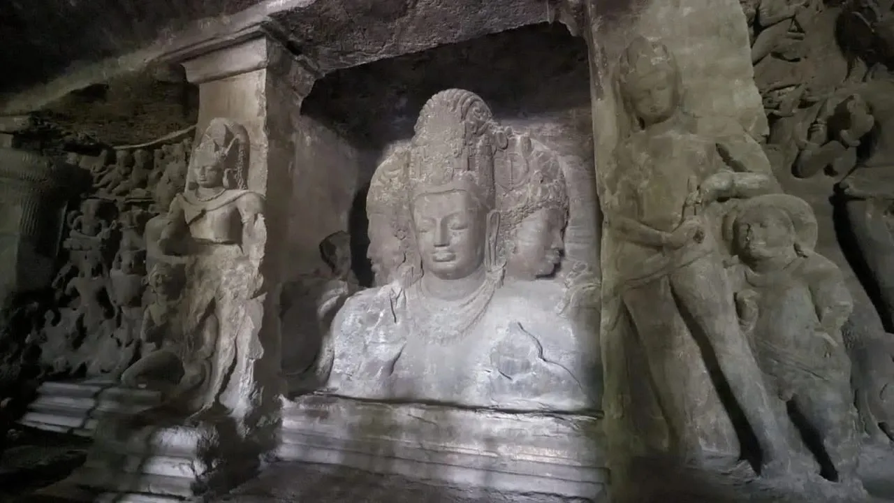 The legendary Trimurti, the 6 metre three-faced Shiva sculpture carved into the basalt rock of the Elephanta Gufa on Elephanta Island
