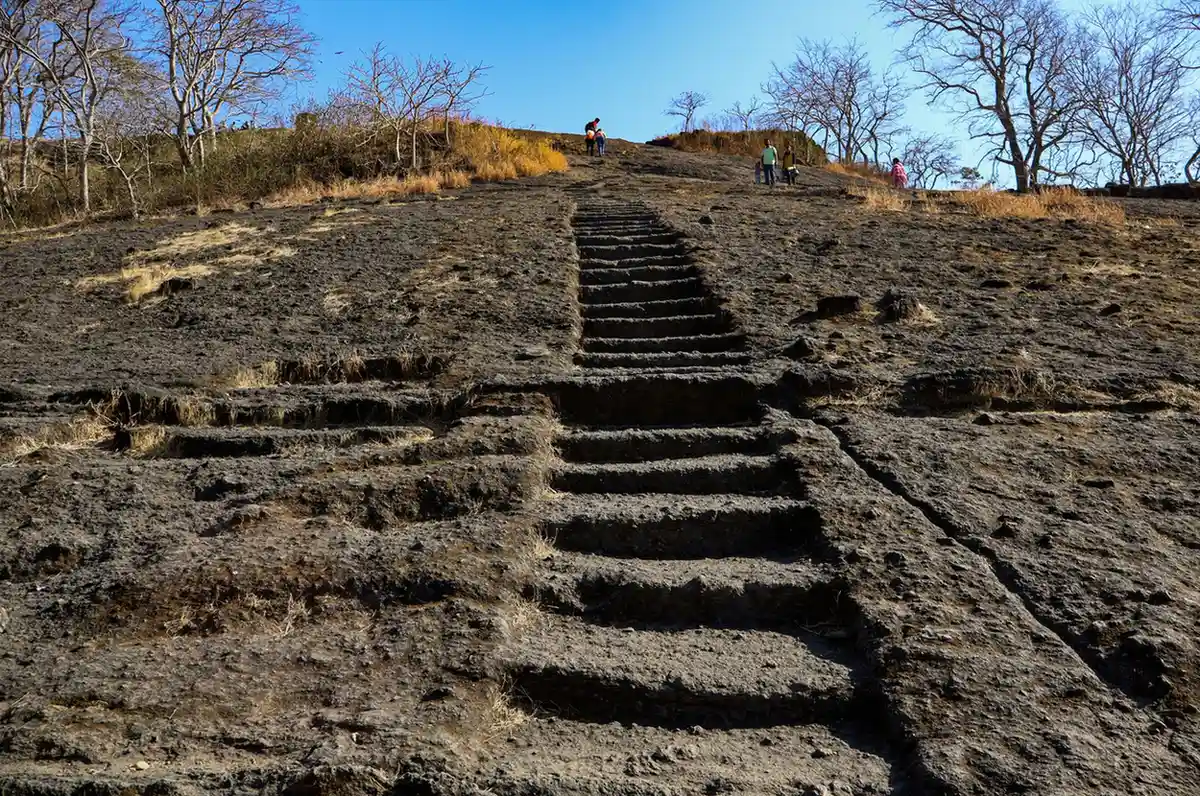 Ancient rock-cut steps carved into basalt rock at Kanheri Caves Mumbai inside Sanjay Gandhi National Park