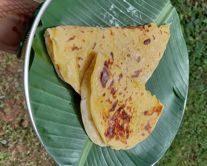 Folded Puran Poli sweet flatbread served on a banana leaf - Cityscape Mumbai Tours food guide