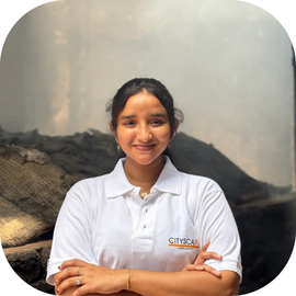 Cityscape Mumbai Tours, Sharon, Tour Guide, smiling in a branded polo shirt in Dharavi