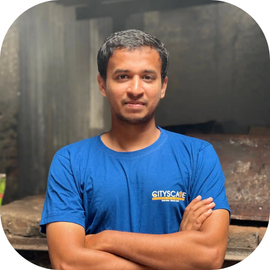 Cityscape Mumbai Tours, Shubhan, Tour Guide, standing with arms crossed in a branded t-shirt in Dharavi